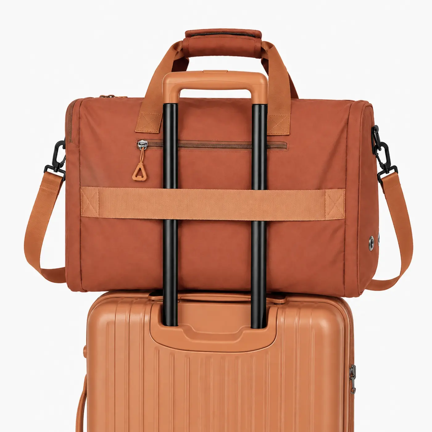 Orange TTrippi bag secured to a suitcase